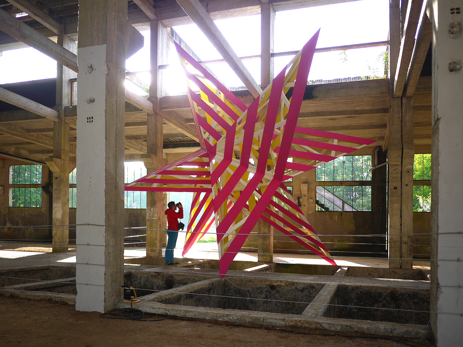 Akoaki installed two stars, each spanning over 30 feet, in a defunct tannery with all elements produced and assembled on-site. Pop It Up, Amilly, France, 2013. Credit: Akoaki
