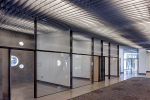 The perforated metal fin ceiling system created a louver that allowed lights, diffusers, sprinklers and AV systems to be stored together out of sight.