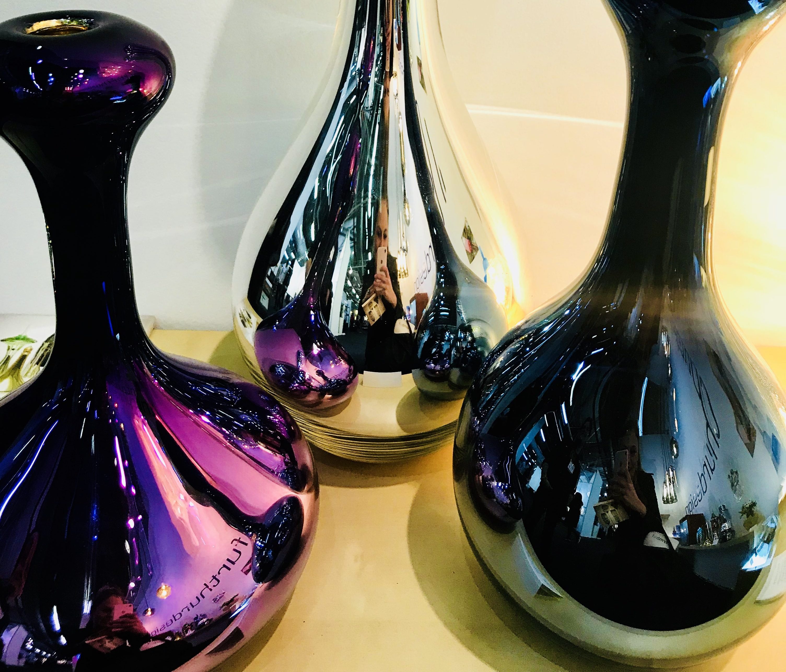 Glassblower William Couig transforms the material into fabulous, shiny metallic-coated vessels.